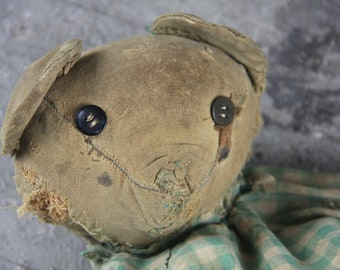 Antique, early, much loved, shabby, and floppy.  One of a kind.  Handmade homemade, stitched body, button eyes, stuffed with straw batting