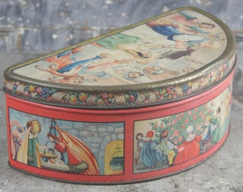Lakeside Biscuit Company half circle fruitcake tin with Renaissance, Christmas-themed lithographed illustrations of fairy tale scenes