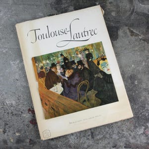 May include: A vintage book titled "Toulouse-Lautrec" with a full-color illustration of a Parisian cafe scene on the cover. The book features 16 beautiful full-color prints.