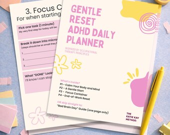 May include: A Gentle Reset ADHD Daily Planner with a pink and yellow design, alongside a worksheet. The planner includes sections for focus, and breaking down tasks. A yellow pen and tape are also visible.