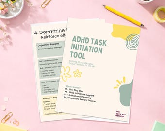 May include: Two printed worksheets on a pink surface. The top sheet is titled "ADHD Task Initiation Tool" with a floral design. The second sheet is titled "4. Dopamine/Reinforce eff". Stationery items, including pens and paperclips, are scattered around.