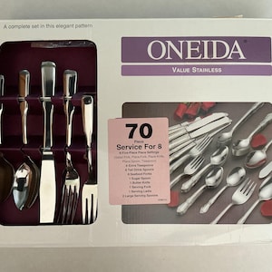 May include: A boxed set of Oneida stainless steel silverware. The box features a purple and white color scheme with the text "ONEIDA VALUE STAINLESS" and "70 Piece Service For 8". The set includes forks, spoons, and knives.