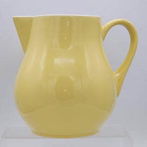 May include: A set of three ceramic mugs with a speckled, matte finish. The mugs are in shades of cream, light gray, and dark gray. Each mug has a simple, minimalist design, perfect for coffee or tea.