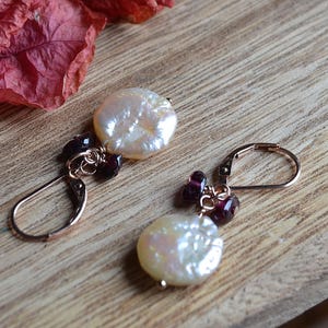 Moonlight pearl coin dangle earrings on rose gold.