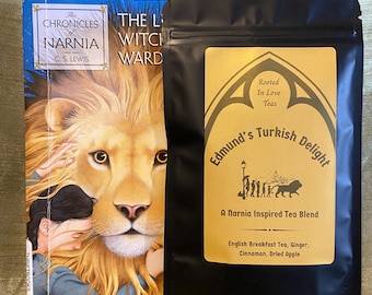 May include: A copy of The Chronicles of Narnia: The Lion, the Witch and the Wardrobe book next to a black pouch of Edmund's Turkish Delight tea. The tea label features a gold background with black text and a silhouette of characters and a lion.