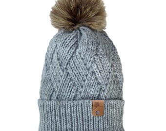 Women's Winter Hat Chunky Cable Knit Beanie Alaska Leather Patch Faux Fur Pom Pom