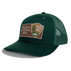 May include: A green trucker hat with a brown patch featuring the Sequoia National Park logo and the text "Sequoia National Park" and "National Park Service".