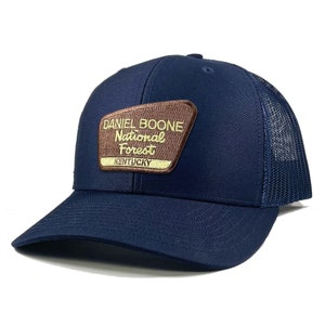 May include: A navy blue trucker hat with a brown patch that reads "Daniel Boone National Forest Kentucky".