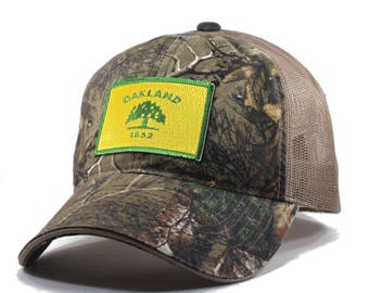 Homeland Tees Oakland Flag Hat - Realtree Camo Trucker Men's Cap