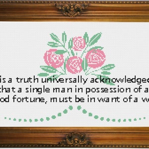 May include: A cross-stitch embroidery featuring a quote from Jane Austen's Pride and Prejudice: "It is a truth universally acknowledged, that a single man in possession of a good fortune, must be in want of a wife." The embroidery includes a pink rose bouquet with green leaves.