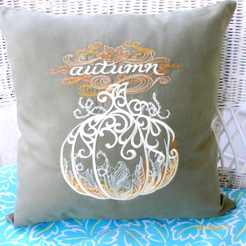 Dark Sage Green velvet pillow cover with autumn embroidered in Ivory with a gold and brown design behind Autumn. Embroidered in the center is a large Ivory pumpkin with swirls and a lace affect with Ivory embroidered over the brown and gold.