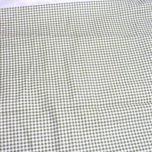 May include: Close-up of a fabric with a small, olive green and white gingham pattern. The fabric is slightly wrinkled, suggesting it is a textile. The pattern is evenly spaced and covers the entire surface.
