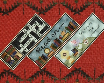 May include: Three colorful bookmarks with different designs. The first bookmark features a crossword puzzle with the word "books" in the center. The second bookmark has the words "Read on" in a blue and white font. The third bookmark has the words "Treasure the moment" in a blue and white font.