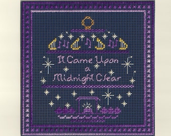 May include: A navy blue cross-stitch design with the text "It Came Upon a Midnight Clear" in lavender. The artwork features gold-coloured musical instruments and starbursts, framed by a purple border, suitable for Christmas.
