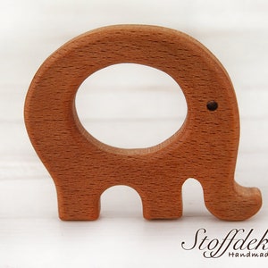 May include: A wooden elephant teether with a round hole in the middle. The teether is made of beech wood and is finished with bio linseed oil. The teether is certified safe for babies and is free of harmful substances.