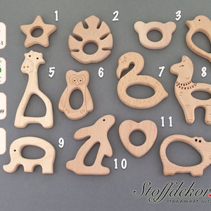 May include: Twelve wooden teethers in various animal shapes, including a giraffe, owl, flamingo, llama, bunny, and hippo. The teethers are made of natural beech wood and are safe for babies to chew on. DIN EN 71-3, FSC, Schadstoff Frei, Buche.