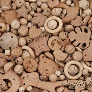 May include: A large assortment of natural wood beads and shapes, including stars, hearts, circles, and animal figures. The beads are perfect for crafting necklaces, bracelets, and other jewelry.