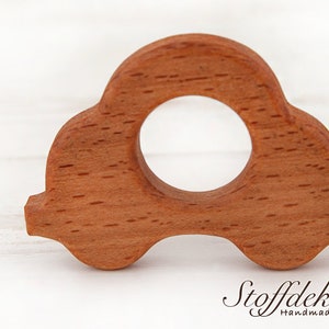 May include: A wooden car-shaped teether for babies. The teether is made of beech wood and is finished with natural oil. It is certified safe for babies and meets the DIN EN 71-3 safety standard.