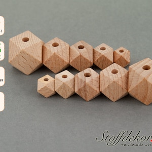 Può includere: Un set di otto perline di legno di diverse dimensioni, ciascuna con una forma esagonale e un foro al centro. Le perline sono in legno di faggio naturale e non sono finite.