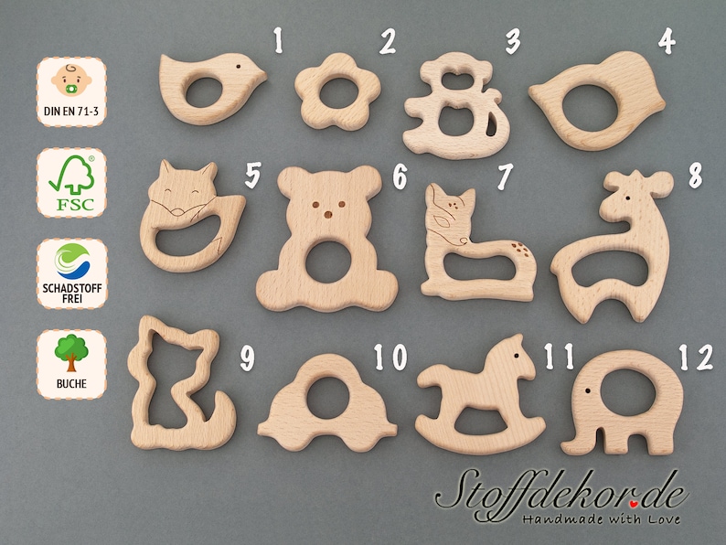 May include: Twelve wooden teethers in various animal shapes, including a bird, flower, monkey, deer, fox, bear, cat, giraffe, and elephant. The teethers are made of natural wood and are designed for babies to chew on.