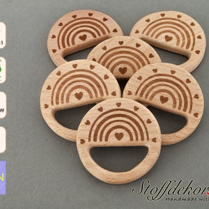 May include: Six wooden teethers with a rainbow and hearts design. The teethers are made of beech wood and are safe for babies. They are handmade with love.