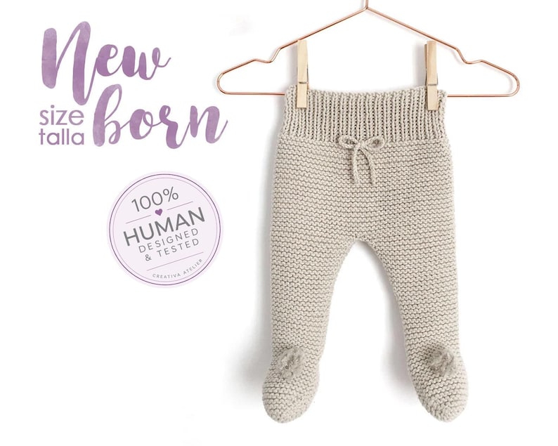 May include: Beige knit newborn trousers with a ribbed waistband, a small decorative drawstring bow at the centre, and integrated footies. The text New size talla born and a circular 100% HUMAN DESIGNED & TESTED badge are visible.