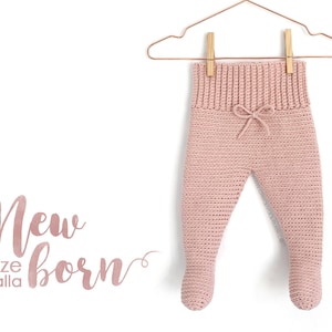 May include: Pink crocheted baby pants with a drawstring waist hanging on a gold hanger. The text "New born size talla" is written below the pants.