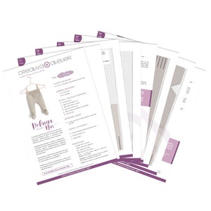 May include: A multi-page knitting pattern document titled Creativa Atelier Polaina Nur, featuring a beige knitted baby garment on a hanger, detailed text instructions, technical charts, and diagrams printed on white paper with purple accents.