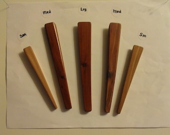 May include: Five wooden dowels of varying lengths labeled "Sm", "Med", "Lrg", "Med", and "Sm".