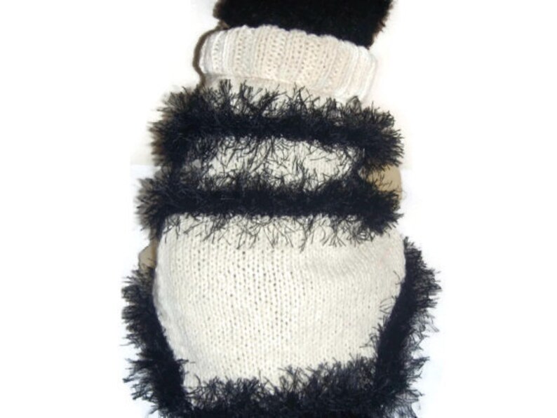 Dachshund dog sweater in chunky cream knit trimmed with black fun fur knitting yarn fringe.