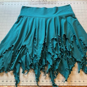 May include: A white ceramic mug with a black handle and the text "But First, Coffee" in a black, bold font. The mug is on a white surface. The mug is 4 inches tall.