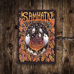 May include: A watercolor illustration of a jack-o'-lantern with a spooky, toothy grin. The lantern is surrounded by a swirling pattern of leaves, stars, and ghosts. The text "SAMHAIN" is written in a stylized font at the top of the image.