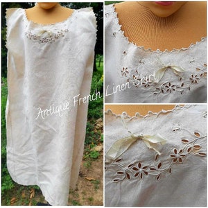 May include: Antique French linen shirt with delicate eyelet embroidery and a satin ribbon bow. The shirt is sleeveless and has a scoop neck.