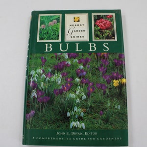 以下が含まれることがあります： 表紙に様々な花が描かれた、「Hearst Garden Guides Bulbs」というタイトルの緑色の本。この本は、庭師のための包括的なガイドであり、ジョン・E・ブライアン編集によるものです。
