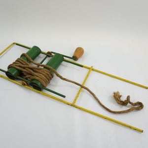 May include: A white ceramic mug with a black handle and the text "But First, Coffee" in a black, handwritten-style font. The mug is on a white surface.