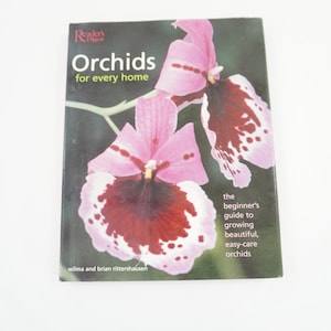 May include: A book titled "Orchids for Every Home" with a close-up of pink and maroon orchids on the cover. The book is a beginner's guide to growing beautiful, easy-care orchids.