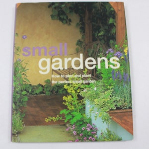 May include: Book cover with the title "small gardens" in purple and white text. The subtitle is "How to plan and plant the perfect small garden". The cover features a photo of a small garden with a wooden bench, green plants, and a stone wall.