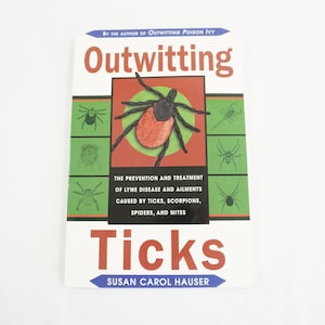 May include: A book titled "Outwitting Ticks" by Susan Carol Hauser. The book cover features a red tick with a green background and illustrations of other insects.