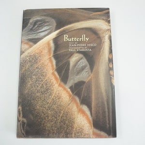 May include: A hardcover book titled "Butterfly" with a close-up image of a butterfly wing on the cover. The cover features text by Jean-Pierre Vesco and photographs by Paul Starosta. The book has a white background.