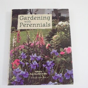 May include: Book cover with a photo of a garden with purple irises, pink and white foxgloves, and other flowers. The title of the book is "Gardening with Perennials" and the author is Fern Marshall Bradley.