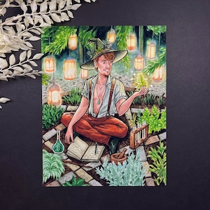 May include: A watercolor painting of a person wearing a green witch hat and brown pants sitting in a garden with a book and a mortar and pestle. The person is surrounded by green plants and glowing lights.