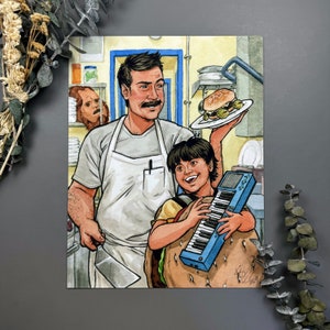 May include: A man wearing a white apron and a young person holding a blue keyboard. The man is holding a plate with a hamburger on it. The background is a kitchen with a red and white chequered floor.