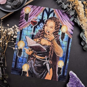 May include: Watercolor illustration of a woman in a black dress, holding a book and a glass of red wine. The artwork features candles, a window, and a decorative dagger. The woman has long braided hair and is wearing a necklace.