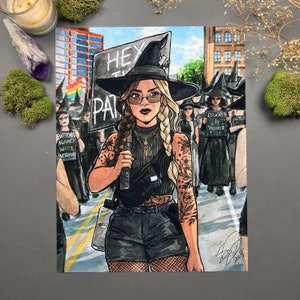 May include: A digital illustration of a woman dressed as a witch, wearing a black witch hat, black clothing, and a black fanny pack. She is holding a microphone and marching in a protest with other witches. The signs in the illustration read "HEX THE PATRIARCHY" and "EDUCATION IS POWER".