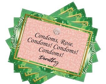 May include: A stack of green cards with a gold border and a pink center. The center text reads "Condoms, Rose. Condoms! Condoms! Condoms! Dorothy" with a small illustration of a woman's face.