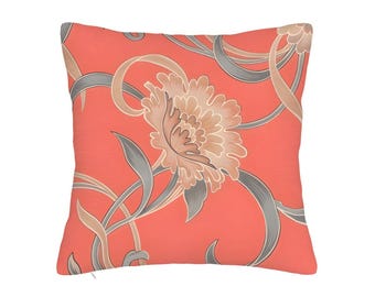 May include: Square coral-colored decorative pillow with a floral pattern. The design features a large, stylized flower in shades of beige and gray, surrounded by swirling gray and beige stems and leaves. The pillow has a textured appearance.
