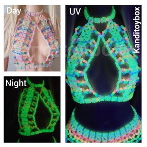 May include: A halter-style top constructed from multi-colored plastic beads in a lattice pattern. The top features a high neck and a central cutout. It is shown in three states: daylight, glowing under UV light, and glowing in the dark, labeled Kanditoybox.