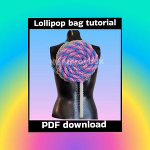 May include: A beaded lollipop-shaped bag in shades of pink, blue, and white, displayed on a mannequin. The bag has a spiral design and a white beaded stick. Text on the image reads "Lollipop bag tutorial" and "PDF download."