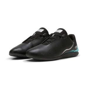 May include: A pair of black low-top sneakers featuring a perforated side panel, black laces, and a silver and teal accent on the heel. The heel area displays the text Mercedes-AMG Petronas Motorsport. The shoes have a black sole and a smooth finish.