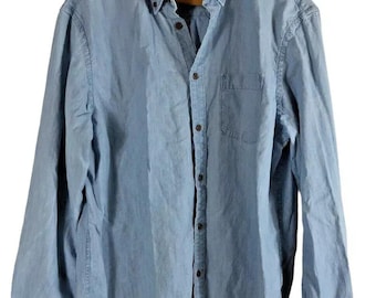 May include: A light blue button-down shirt with long sleeves, a chest pocket, and a button-down collar. The shirt is made of a soft, denim-like material and is hanging on a wooden hanger. The brand name "Old Navy" is visible on the collar.